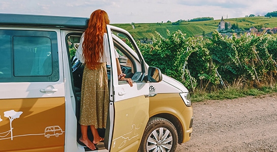 a girl with read hair standing