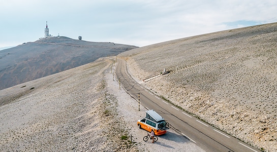 oranger campervan parking on the side of the road