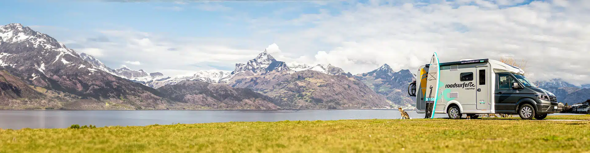 Motorhome parking by the lake with mountain scenery in the background