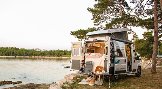 decorated fiat ducato by a lake