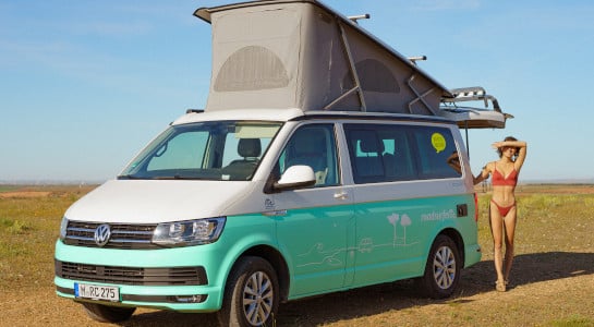 girl in red bikini next to a campervan in summer
