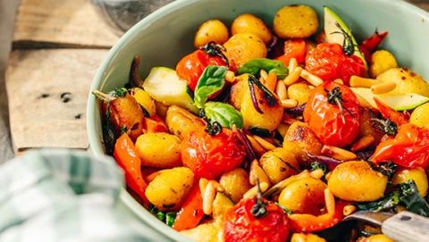 Vegetarian gnocchi with vegetables, close-up from the side