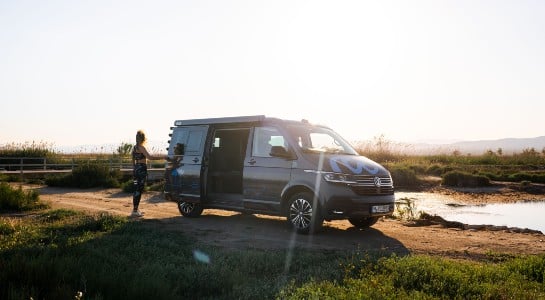 A woman preparing to go jogging in her VW California camper
