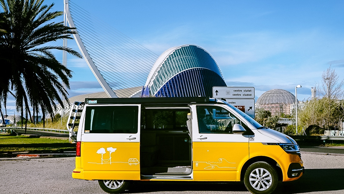 Yellow VW camper standing in front of the Ciutat de les Arts in Valencia